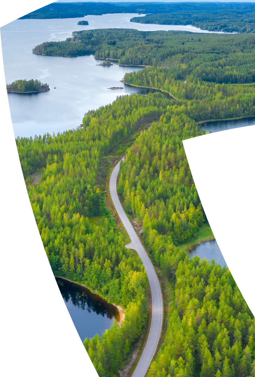 Forest and lakes landscape with road running through it.